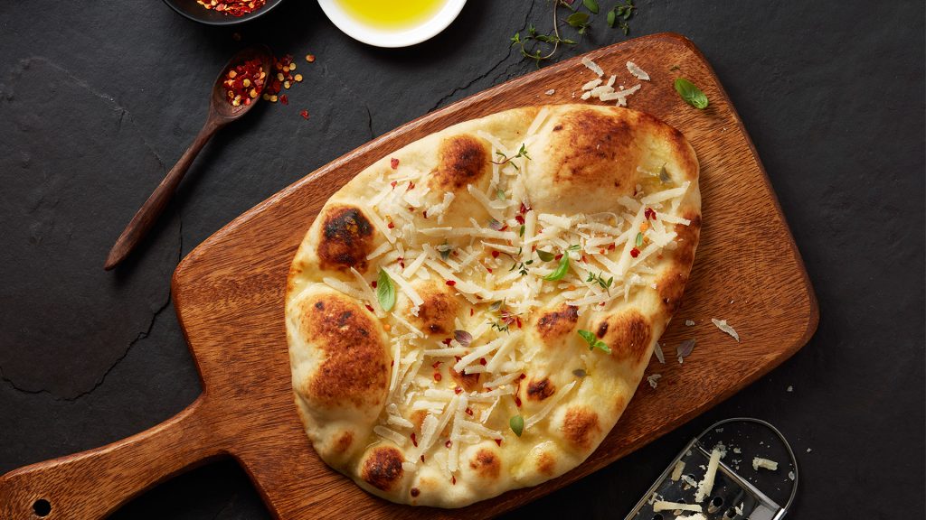 warm naan topped with oil and cheese